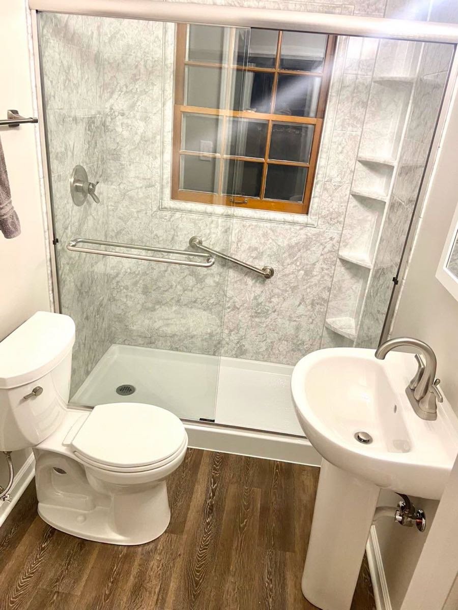 Bathroom with a walk-in shower and pedestal sink